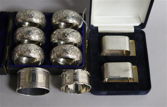 A cased set of six late Victorian silver napkin rings, Birmingham, 1897, a later pair and two other napkin rings.